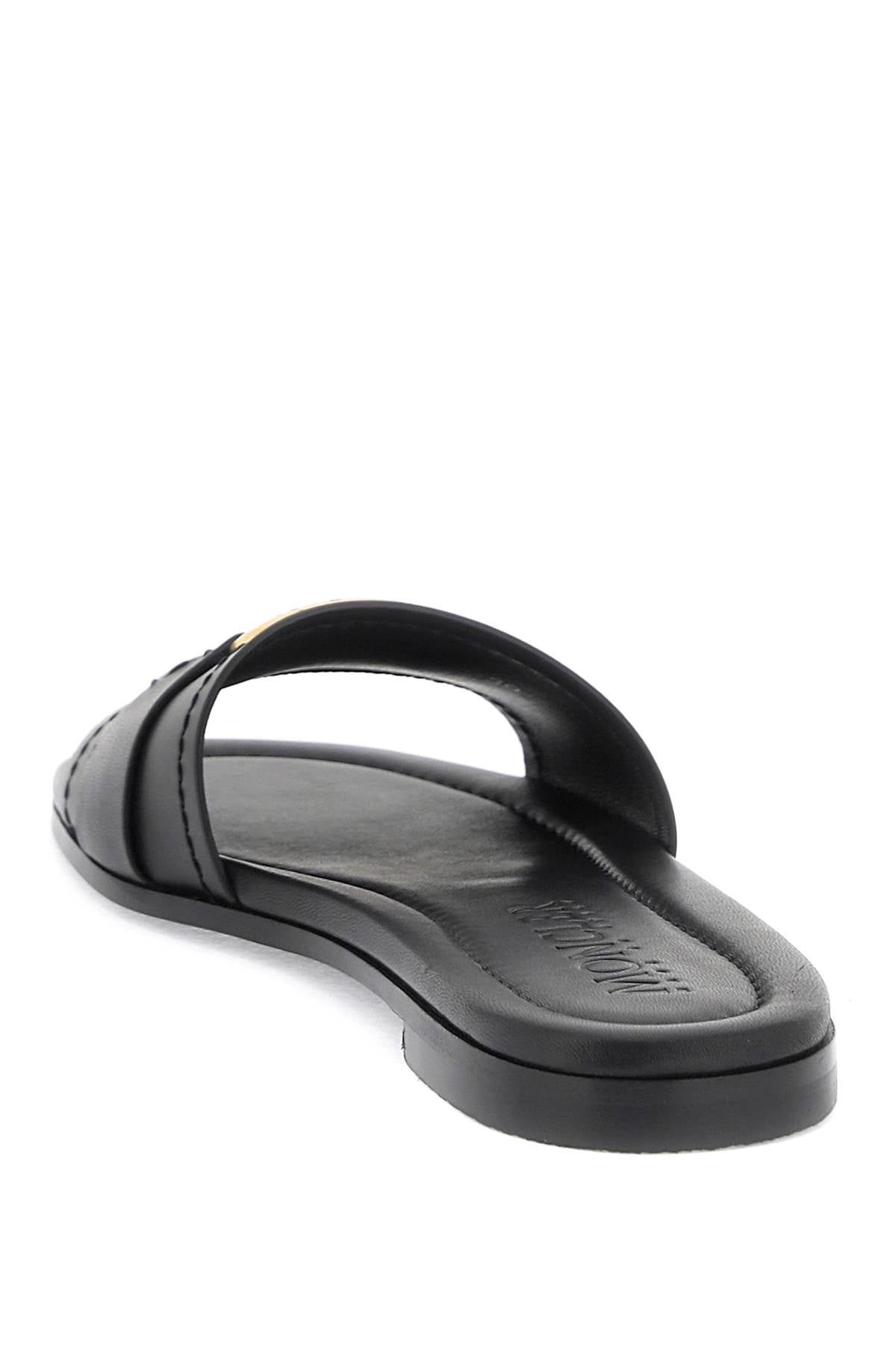 MONCLER Black Calfskin Slide for Women Featuring a Round Toe and Gold Metal Ring Band with Engraved Logo