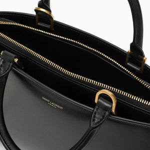 SAINT LAURENT Small Shiny Black Leather Duffle Handbag with Bronze Metal Accents and Adjustable Strap for Women