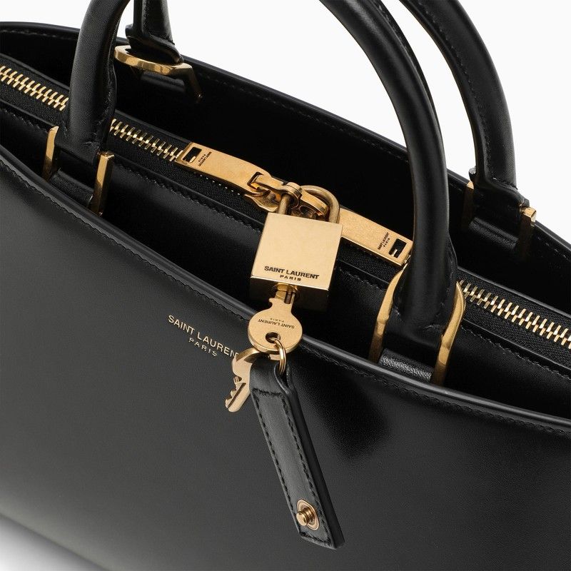 SAINT LAURENT Small Shiny Black Leather Duffle Handbag with Bronze Metal Accents and Adjustable Strap for Women